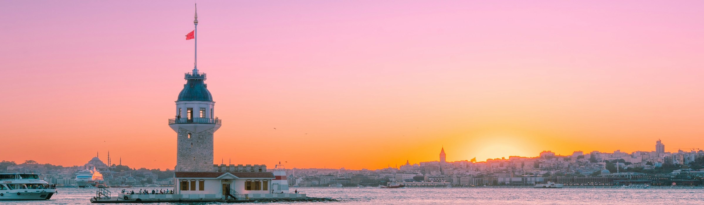 Maiden's Tower, mosque silhouettes and sunset seen from Uskudar, Istanbul